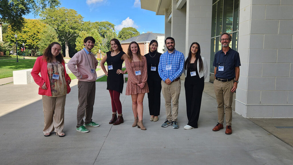 Group of undergraduate researchers standing outside of a building.